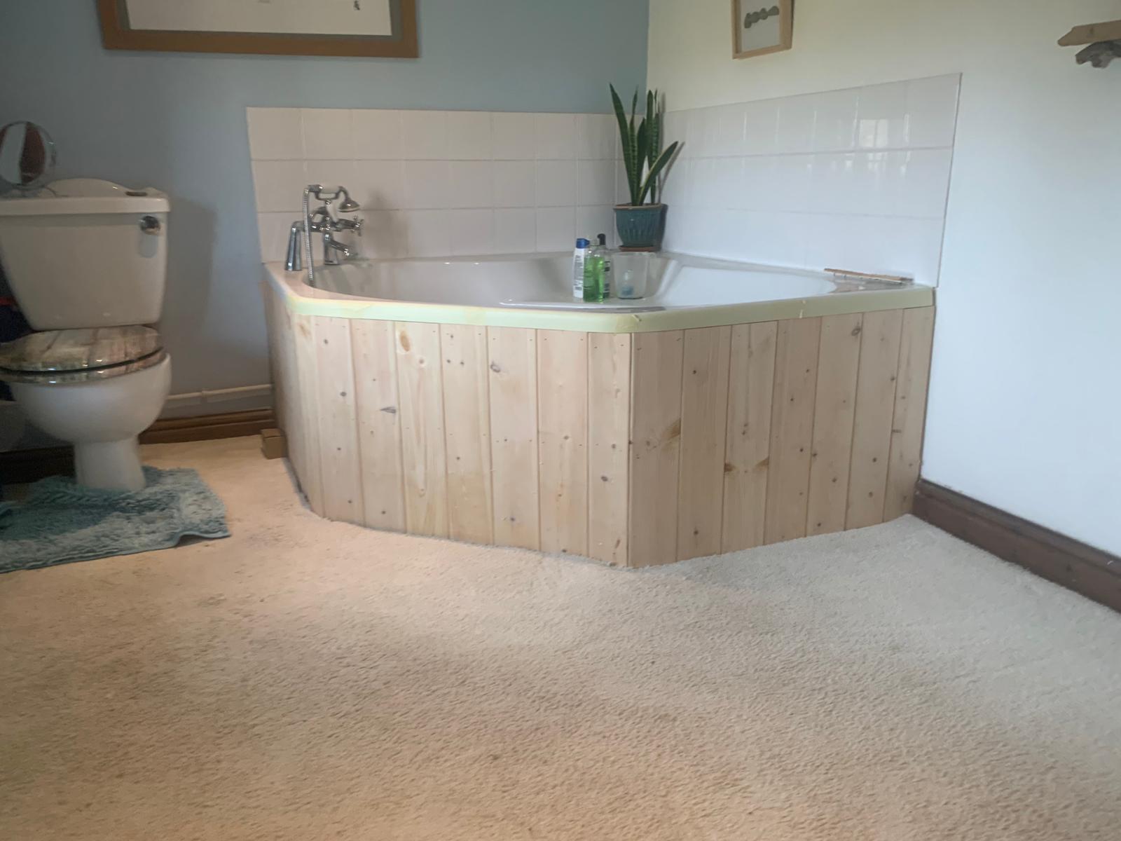 Bathroom fitting in Sudbury Suffolk by David Price Building Services with new corner bath, panelling and tiled splashback