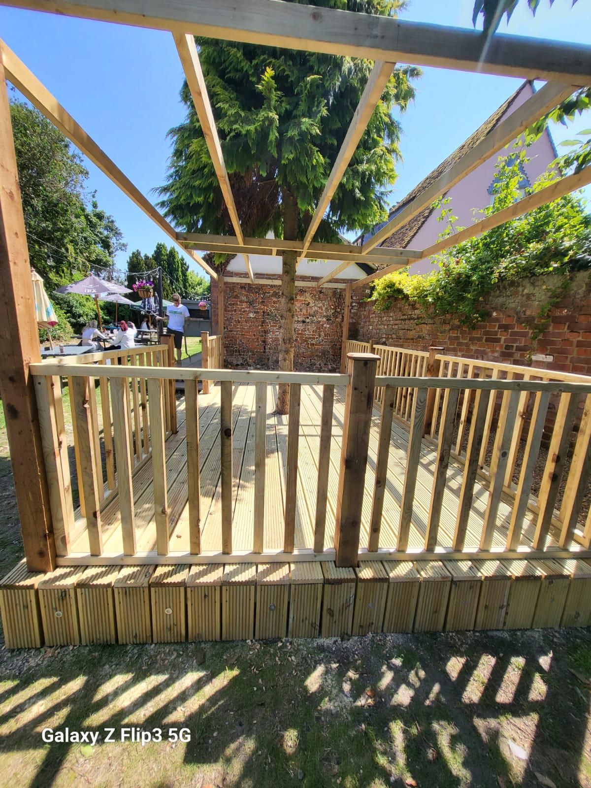 Decking with timber balustrade in Suffolk garden