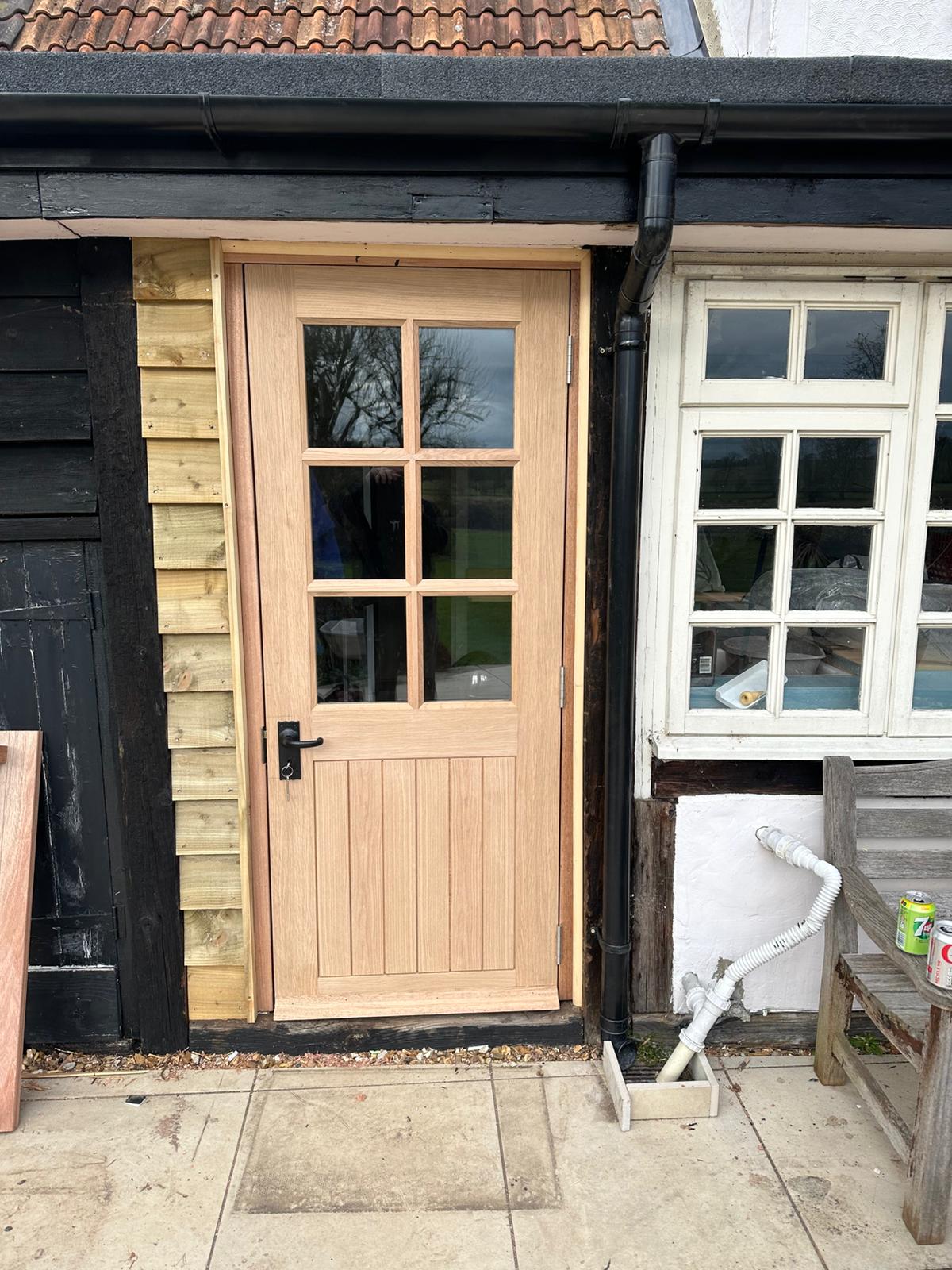 Traditional oak door installation on a Suffolk outbuilding