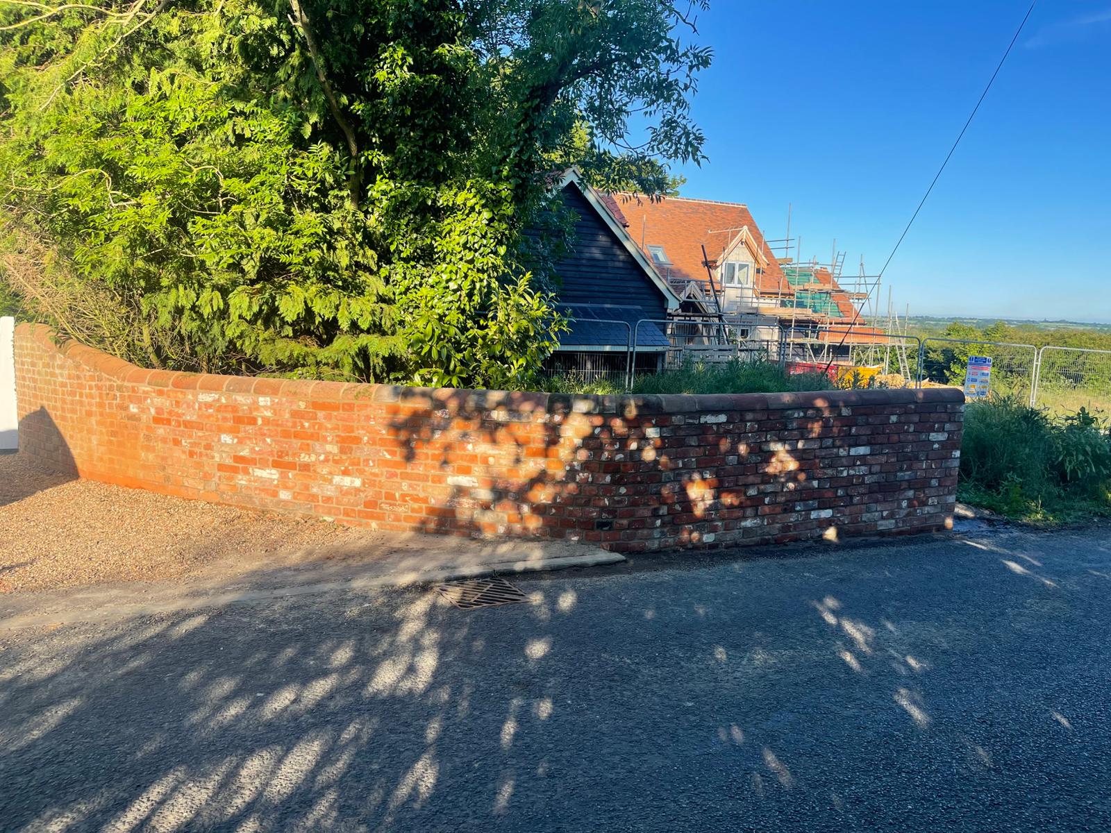 Curved brick boundary wall in Suffolk